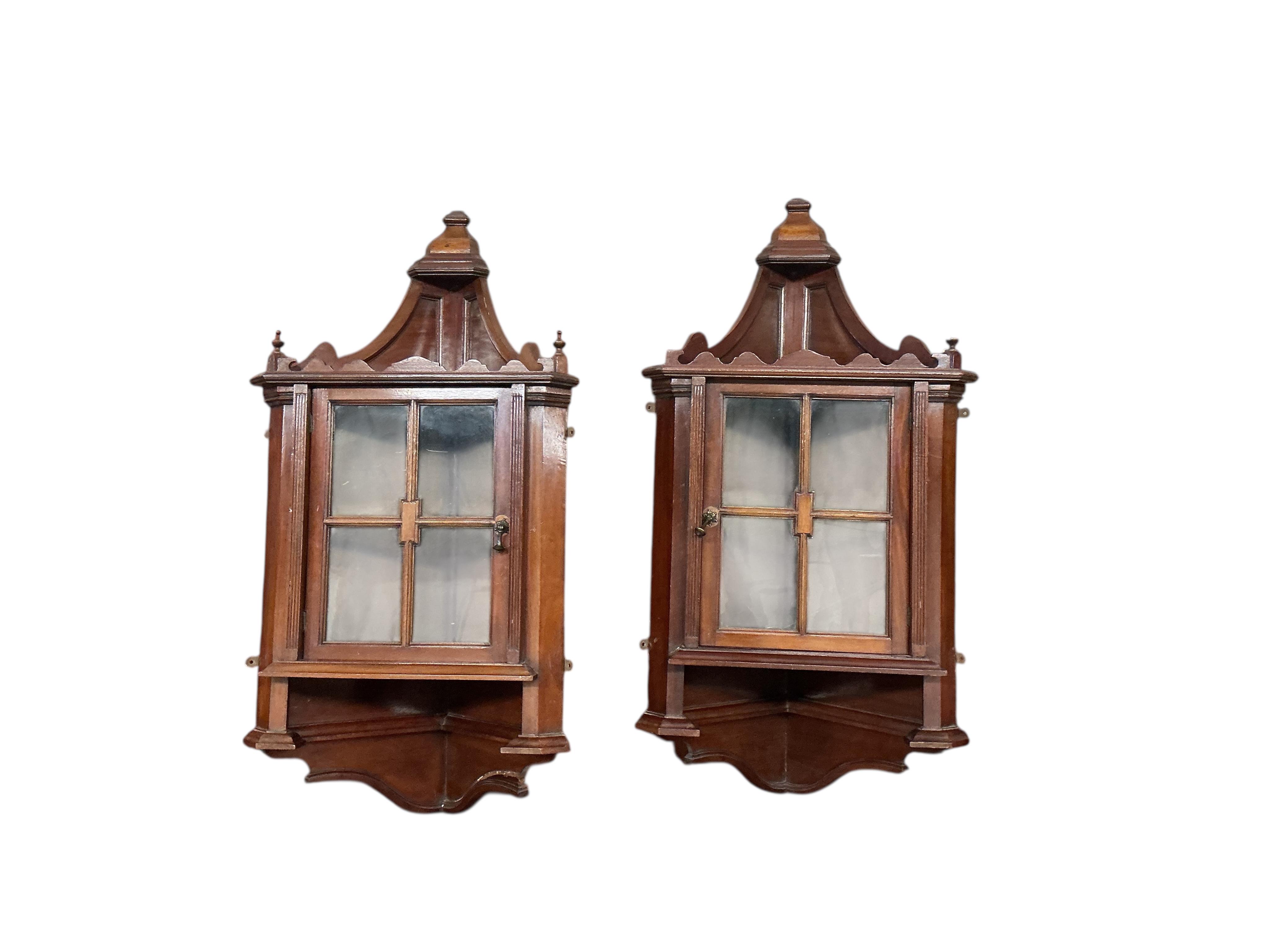 A pair of small late Victorian mahogany hanging corner cabinets, width 48cm, depth 26cm, height 96cm